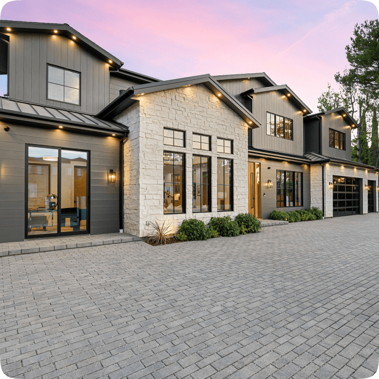 Modern house with stone exterior at sunset.